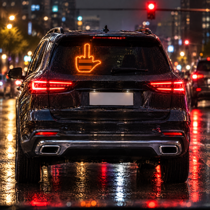Middle-finger gesture glowing in an SUV rear window at night
